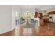 Cozy dining area with a modern light fixture, beautiful hardwood floors, and an adjacent kitchen at 2251 Barrowcliffe Nw Dr, Concord, NC 28027