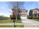 Inviting two-story brick home with a two-car garage, landscaped front yard, and charming balcony at 2251 Barrowcliffe Nw Dr, Concord, NC 28027