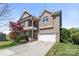 Charming two-story brick home featuring a two-car garage and a beautifully landscaped front yard at 2251 Barrowcliffe Nw Dr, Concord, NC 28027