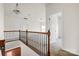 Hallway with wood railing, carpeted floors, and access to bedrooms at 2251 Barrowcliffe Nw Dr, Concord, NC 28027