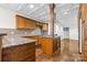 Kitchen featuring tiled backsplash, granite countertops, wooden cabinets, and an island with an overhead vent at 2251 Barrowcliffe Nw Dr, Concord, NC 28027