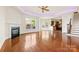 Bright living room featuring a fireplace, ceiling fan, and a large window with natural light at 2251 Barrowcliffe Nw Dr, Concord, NC 28027