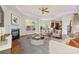 Bright living room featuring a fireplace, ceiling fan, and a large window with natural light at 2251 Barrowcliffe Nw Dr, Concord, NC 28027