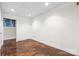 An unfinished room with a tiled ceiling, neutral walls, concrete floors, and a view into a hallway at 2251 Barrowcliffe Nw Dr, Concord, NC 28027