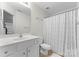 Clean bathroom featuring a vanity, toilet, and a shower with a decorative curtain at 2259 Crosscut Dr, Charlotte, NC 28214