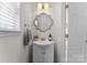 Bathroom featuring a sink with vanity, decorative mirror, and modern fixtures at 2259 Crosscut Dr, Charlotte, NC 28214