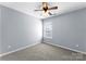 Cozy bedroom with neutral carpeting, a ceiling fan, and a bright window offering natural light at 2259 Crosscut Dr, Charlotte, NC 28214