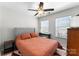 Bedroom with a ceiling fan, gray upholstered headboard and an orange comforter at 2259 Crosscut Dr, Charlotte, NC 28214