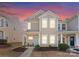 Charming two-story townhouse boasts a cozy front porch and welcoming curb appeal with meticulously maintained landscaping at 2259 Crosscut Dr, Charlotte, NC 28214