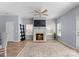Bright living room featuring a cozy fireplace, ceiling fan, and modern flooring at 2259 Crosscut Dr, Charlotte, NC 28214