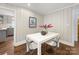 Bright dining area featuring a modern white table, sleek chairs, and hardwood floors, perfect for entertaining at 2908 Enfield Rd, Charlotte, NC 28205