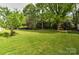 Spacious backyard surrounded by mature trees, offering a private and serene outdoor setting at 3400 Tracelake Dr, Matthews, NC 28105