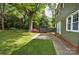 Beautiful backyard featuring lush lawn, mature trees, and patio area perfect for outdoor entertaining at 3400 Tracelake Dr, Matthews, NC 28105