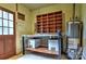 Basement area featuring a workbench, built-in shelving, and a water heater at 3400 Tracelake Dr, Matthews, NC 28105