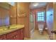 Cozy bathroom with vintage wallpaper, a single sink vanity, and a shower with glass door at 3400 Tracelake Dr, Matthews, NC 28105