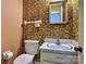 Cozy bathroom with wallpaper, toilet and vanity with chrome faucet, offering functionality in a compact space at 3400 Tracelake Dr, Matthews, NC 28105