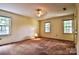 Bedroom with two windows, carpet, and a simple ceiling fan at 3400 Tracelake Dr, Matthews, NC 28105