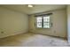 Bedroom featuring neutral walls, carpet flooring, and a bright window, creating a serene atmosphere at 3400 Tracelake Dr, Matthews, NC 28105