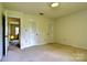 Bedroom with plush carpeting, white doors and walls, providing a calming and comfortable space at 3400 Tracelake Dr, Matthews, NC 28105