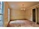 Spacious dining room with classic wallpaper, a chandelier, and large windows, ideal for Gathering meals at 3400 Tracelake Dr, Matthews, NC 28105