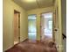 Hallway view featuring multiple doorways, carpet, and closet at 3400 Tracelake Dr, Matthews, NC 28105
