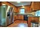 Traditional kitchen with stainless steel refrigerator, wood cabinets, and black appliances, ready for your culinary creations at 3400 Tracelake Dr, Matthews, NC 28105