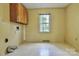 Functional laundry room featuring overhead cabinets, and ample space for laundry appliances at 3400 Tracelake Dr, Matthews, NC 28105