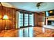 The living room showcases gleaming hardwood floors, a brick fireplace, and french doors to outside, creating a cozy ambiance at 3400 Tracelake Dr, Matthews, NC 28105