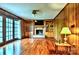 Spacious living room featuring a fireplace with built-in shelves and access to the backyard through french doors at 3400 Tracelake Dr, Matthews, NC 28105