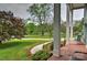 Inviting porch view showcasing the expansive front yard and picturesque landscaping at 3400 Tracelake Dr, Matthews, NC 28105