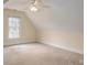 This bedroom boasts ample natural light through a large window, complemented by neutral walls and a ceiling fan at 3516 Araglin Dr, Gastonia, NC 28056