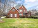 Charming two-story red brick home with manicured lawn and lush landscaping at 3516 Araglin Dr, Gastonia, NC 28056