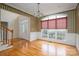 Foyer with hardwood floors, front door, and dining area with a large window at 3516 Araglin Dr, Gastonia, NC 28056