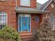 Close-up of the home's front entrance, showing the blue front door and brick steps at 3516 Araglin Dr, Gastonia, NC 28056