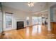 Spacious living room featuring a fireplace, hardwood floors, and seamless connection to the kitchen at 3516 Araglin Dr, Gastonia, NC 28056