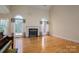 Bright living room with hardwood floors, a fireplace, and large windows with natural light at 3516 Araglin Dr, Gastonia, NC 28056