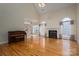 Large living room with a piano, fireplace, and hardwood floors at 3516 Araglin Dr, Gastonia, NC 28056