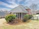 An exterior angle showcasing the house's screened porch, partial fenced yard, and landscaping at 3516 Araglin Dr, Gastonia, NC 28056