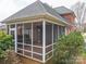 The home's screened porch with brick flooring offers an outdoor space for relaxation and entertaining at 3516 Araglin Dr, Gastonia, NC 28056