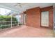 Enjoy the outdoors in this cozy screened porch with brick flooring, ceiling fan and backyard views at 3516 Araglin Dr, Gastonia, NC 28056