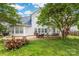 Large backyard with a brick patio and a white house at 4036 Sawmill Trace Dr, Charlotte, NC 28213