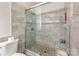 Bathroom featuring a glass-enclosed marble tile shower with rainfall shower head at 4036 Sawmill Trace Dr, Charlotte, NC 28213