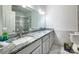 Bathroom featuring double sinks, granite countertops, and a marble tile surround at 4036 Sawmill Trace Dr, Charlotte, NC 28213
