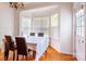 Dining room with hardwood floors, a chandelier, and bay window providing natural light at 4036 Sawmill Trace Dr, Charlotte, NC 28213