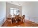 Dining room with a wooden table and chairs situated under a decorative light fixture at 4036 Sawmill Trace Dr, Charlotte, NC 28213