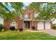 Charming two-story brick home with a three-car garage, manicured lawn and lovely curb appeal at 4036 Sawmill Trace Dr, Charlotte, NC 28213