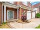 Home's welcoming front entrance features a gray front door, white columns and a two-car garage at 4036 Sawmill Trace Dr, Charlotte, NC 28213