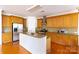 Well-lit kitchen with stainless steel appliances, light wood cabinets, and a large center island with granite countertop at 4036 Sawmill Trace Dr, Charlotte, NC 28213
