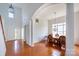 Open floor plan with dining room, staircase, and living room with beautiful floors at 4036 Sawmill Trace Dr, Charlotte, NC 28213