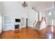 Open-concept living room with hardwood floors, fireplace, and built-in shelving at 4036 Sawmill Trace Dr, Charlotte, NC 28213
